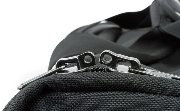 Each of the side pockets and the main pocket have two zipper pulls that come together with rings at the end that a luggage lock can be slipped through to keep your bag locked closed.